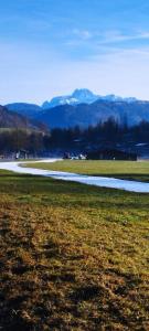 a field with a road and mountains in the background at Zauberblick in Lindenfels