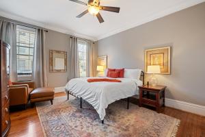 a bedroom with a bed and a ceiling fan at Sleeps 16! Walk To Broughton And River Street!-1-3 in Savannah