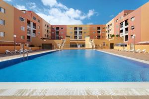 a large swimming pool in an apartment complex at Apartamento Rincon Tropical in Candelaria