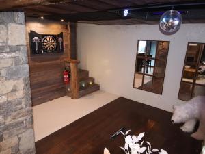 a room with a dart board on the wall at Prestigious Chalet with Pool & Hot tub, Mountain Views for 19 Guests in Vars +47 photos