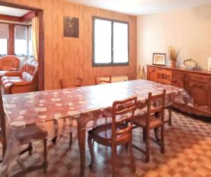 a dining room with a large wooden table and chairs at Maison avec jardin à Vierzon in Vierzon