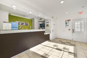 a large room with a counter and green walls at Studio 6 Extended Stay - Tucker, GA - Atlanta Northlake in Tucker
