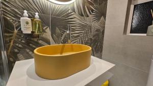 a bathroom with a yellow tub sitting on a counter at Cherrymount Cottage in Enniskillen +37 photos