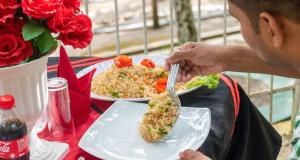 a man eating a plate of food with a fork at Sisiliyana Stone Resort in Gonapola
