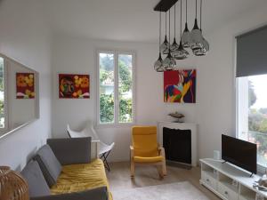 a living room with a couch and a tv at Petit paradis perché au coeur de Nice in Nice