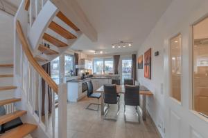 a kitchen and dining room with a table and chairs at Kapitänsdeck 534 in Rechlin