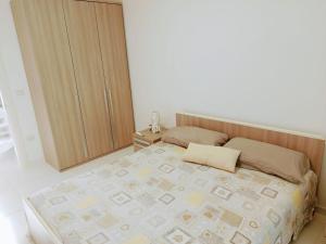 a bedroom with a bed with two pillows on it at La casetta della luna in Castro di Lecce