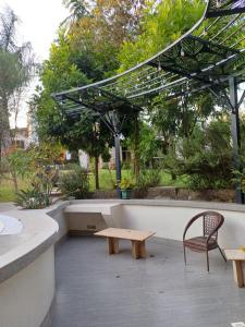 a patio with a bench and a table and chairs at The Other Place 3d lane in Nairobi