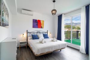a bedroom with a bed and a large window at Villa Mauri Private Pool by Casasol in Nerja +52 photos