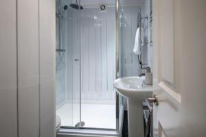 a white bathroom with a shower and a sink at Central Flat-2Bedrooms-2Bath-By FabAccommodation in Bristol