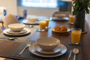 a table with plates and bowls of food and orange juice at Central Flat-2Bedrooms-2Bath-By FabAccommodation in Bristol +14 photos
