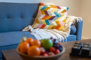 a bowl of fruit on a table next to a couch at Central Flat-2Bedrooms-2Bath-By FabAccommodation in Bristol