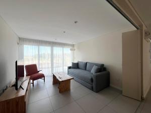 a living room with a couch and a table at Playa y Bosque en Santa Clara MDP - Casona de Tipantú - Dúplex B in Camet Norte