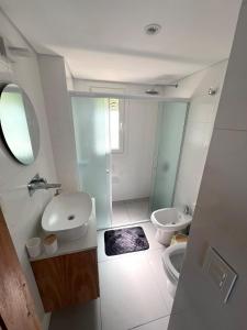 a white bathroom with a sink and a toilet at Playa y Bosque en Santa Clara MDP - Casona de Tipantú - Dúplex B in Camet Norte +25 photos