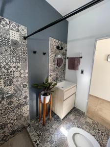a bathroom with a toilet and a sink and a mirror at Casa Ines in Yerba Buena