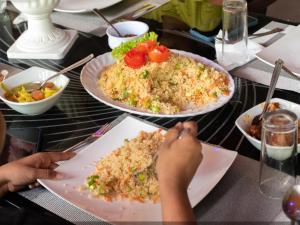 a table with three plates of food on it at Sisiliyana Stone Resort in Gonapola