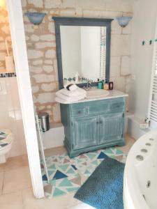 a bathroom with a blue vanity and a mirror at Maison charmante à Courchamps avec vue sur jardin in Courchamps