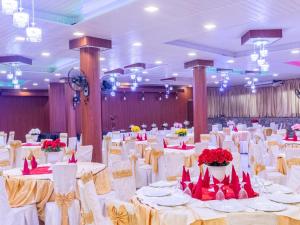 a banquet hall with white tables and red chairs at Sisiliyana Stone Resort in Gonapola
