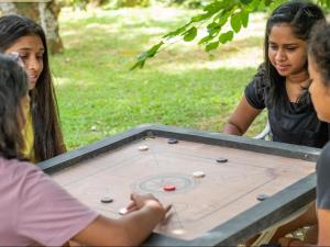 a group of people sitting around a table playing a game at Sisiliyana Stone Resort in Gonapola