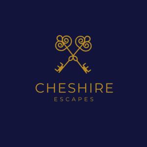 a gold logo with a pair of scissors at Apartment on Watergate Street By Cheshire Escapes in Chester +4 photos