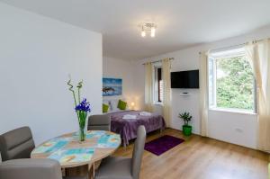 a living room with a table and a bedroom at St Mary Apartments - Dubrovnik in Dubrovnik