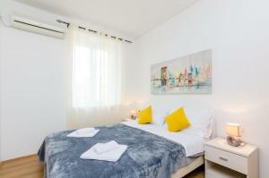 a bedroom with a bed with two towels on it at St Mary Apartments - Dubrovnik in Dubrovnik
