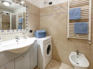 a bathroom with a washing machine and a sink at Appartamenti Elena & Milva in Livigno +66 photos