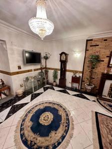 a large room with a clock and a chandelier at Luxury Lodge for Men in Cairo +38 photos