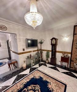 a large living room with a chandelier and a large rug at Luxury Lodge for Men in Cairo