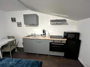 a small kitchen with a sink and a microwave at Azur & Serenity in Clermont-Ferrand +13 photos