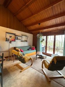 a living room with two chairs and a couch at Chalet18 in Rendeux