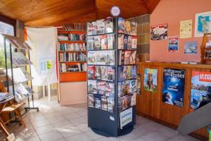 a bookstore with a book shelf filled with books at Camping 4 étoiles - Piscine - ccafgef in La Haye-du-Puits +30 photos