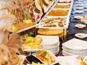 a buffet with plates of food on a table at Sisiliyana Stone Resort in Gonapola