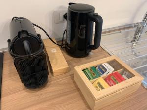 a coffee maker sitting on a table next to a box at IL COMO' DELLA CIVETTA - Nido del Picchio in Villa di Tirano