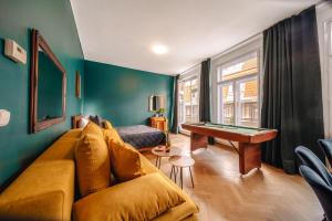 a living room with a couch and a pool table at Wagnerstays Royal Billiard Residence in Prague