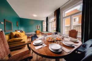 a dining room with a table with plates and wine glasses at Wagnerstays Royal Billiard Residence in Prague