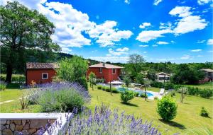 a garden with purple flowers and a red house at Villa Anelia in Roč +33 photos