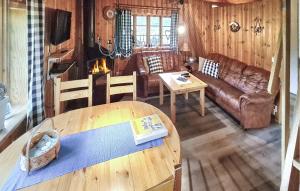 a living room with a couch and a table at Gorgeous Home In Idre With Kitchen in Foskros