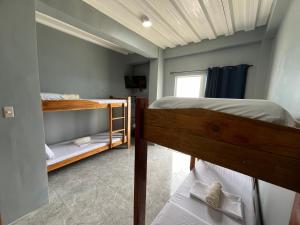 a bedroom with two bunk beds and a window at GOLDEN SUNSET INN in Siquijor +41 photos