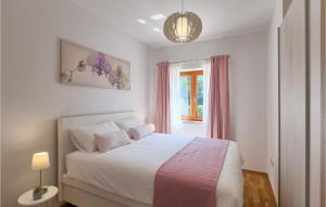 a bedroom with a white bed and a window at Villa Zorica in Stari Pazin