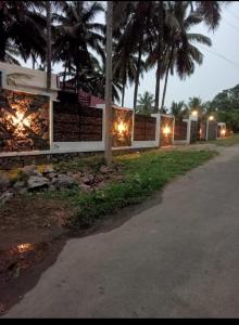 a building with lights on the side of a road at Mountain river farm resort in Agali