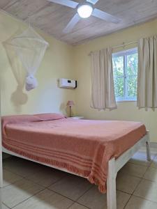 a bedroom with a bed and a ceiling fan at Mis Cabañas La Misión in Salta +46 photos
