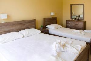 Postel nebo postele na pokoji v ubytování Koulouris Beach Hotel
