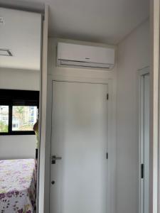 a door leading into a bedroom with a bed at Suíte privada Mariscal in Bombinhas