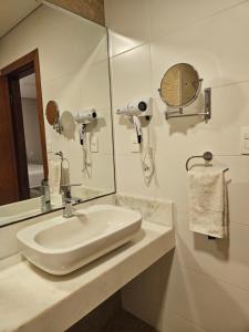 a white bathroom with a sink and a mirror at Casa Garay Hotel 658 in Asuncion