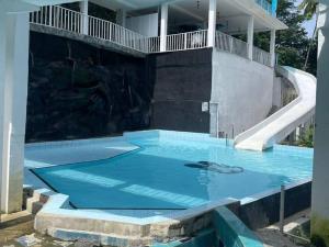 an empty swimming pool with a slide in a house at Sisiliyana Stone Resort in Gonapola