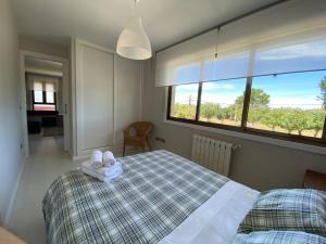 a bedroom with a bed with two towels on it at Housingcoruña Apartamento Playa Miño 03 in Miño