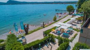 an aerial view of a beach with people on the water at Concept Village Piccola Gardiola in San Felice del Benaco