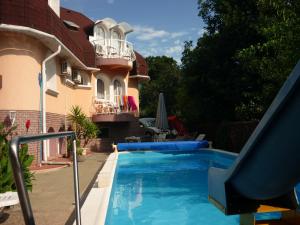 a swimming pool in the backyard of a house at Káptalan vendégház in Balatonalmádi