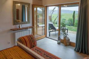a living room with a chair and a mirror at Vale D Sancho Eco Turismo in Aljezur